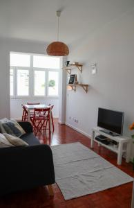 a living room with a couch and a table at Ana's Guesthouse in Sintra