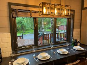 a dining room table with a view of a porch at L02 - The Penrhyn Spa with Hot Tub in Bethesda