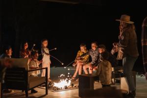 a group of people sitting around a fire at Ofland Escalante in Escalante