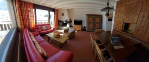 a living room with a couch and a table at Haus Duranna - Arosa Rocks in Arosa