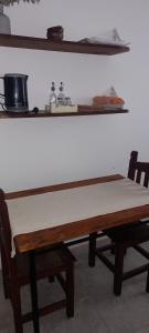 a wooden table with two chairs in a room at La Escala in Corrientes