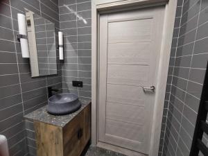 a bathroom with a hat on a counter next to a door at Cosy Apartments in Vilnius Center in Vilnius