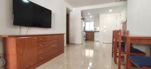 a living room with a television on a wall at Costa Marina I, 1ª linea, 4ª planta, Norte in Oropesa del Mar