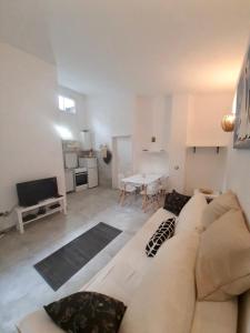 a living room with a couch and a table at Apartment White in Petrovac na Moru