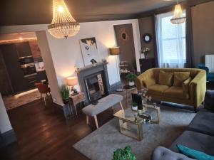 a living room with a couch and a fireplace at Albert Rd Aparthotel in Colne