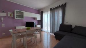 a living room with a table and a couch at Sognando Lampedusa in Lampedusa