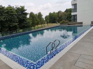 a large swimming pool in a building at Superview Duplex with WiFi & Netflix in Cyberjaya