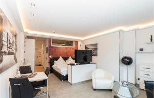 a hotel room with a bed and a desk and a television at Prora Solitaire Panorama 01 in Binz +34 photos