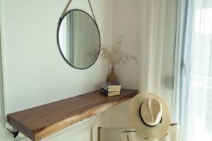 a mirror on a wall next to a chair in a room at Sunset Home Crete in Paránimfoi