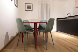 a table and four chairs in a room at Studio Rivoli Loft in Milan