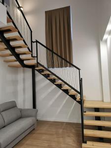 a spiral staircase in a living room with a couch at Villas Camargo.suites in Camargo