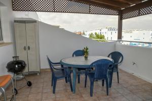 a blue table and chairs on a balcony at The Blue Mile in Paralimni