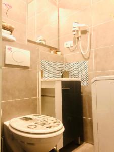 a bathroom with a toilet and a sink at Happy studio 64 St louis in Saint-Louis