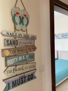 a group of signs on a wall in a room at Kaliakria Infinity Pool Apartment in Topola