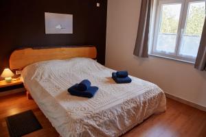 a bedroom with a bed with blue towels on it at Maleluni in Malinska +84 photos