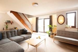 a living room with a couch and a table at Hillside Cottage, countryside views near Llangollen in Corwen
