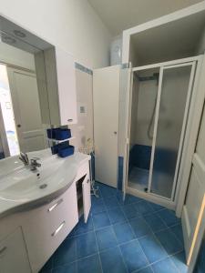 a bathroom with a white sink and a shower at Casa Rossella in Procida