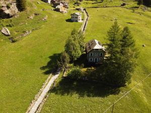 an aerial view of a house on a green field at Il Cortese in Chiareggio