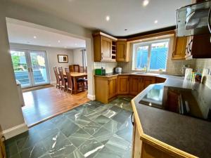 a kitchen with a counter and a table in it at Riverside Cottage 6 guests 4 adults max hot tub in Backbarrow