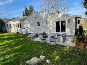 a white house with a picnic table in the yard at Shore Drive - 2 Bedroom/2 Bath/Bunk/Queen Oasis in Waterford