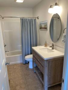 a bathroom with a sink and a toilet and a mirror at Shore Drive - 2 Bedroom/2 Bath/Bunk/Queen Oasis in Waterford