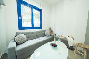 a living room with a couch and a table at Sunset Home Crete in Paránimfoi