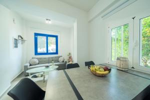 a living room with a bowl of fruit on a table at Sunset Home Crete in Paránimfoi
