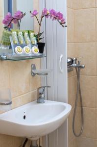 a bathroom with a sink and a mirror at Seaside apartments in Alikí