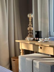 a wooden table with two cups on top of it at La Vigie, Spa in Spa
