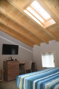 a bedroom with a bed and a skylight at Casale al Foino in Induno Olona