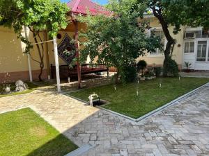 a house with a park with a bench in the yard at Hotel Han in Samarkand