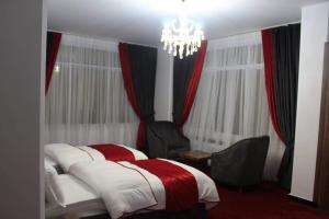 a bedroom with a bed and a chandelier at Golden Star Hotel & Restaurant in Kabul