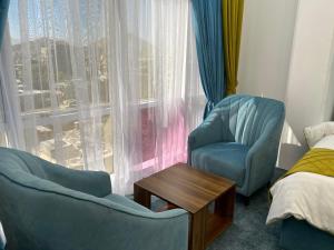 a room with two chairs and a table and a window at Golden Star Hotel & Restaurant in Kabul