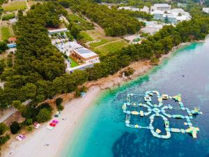 an aerial view of a beach with a water park at Zlatni Rat Beach Resort in Bol