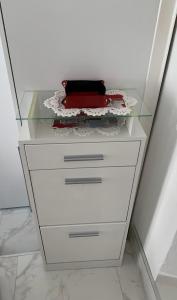 a dresser with a glass top and a drawer at Cannes 3 min from Congress Palace, Croisette, Beaches in Cannes