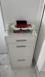 a dresser with a glass top and a drawer at Cannes Apartment close to Congress Palace, Croisette, Beaches in Cannes