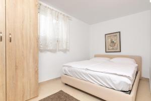 Postel nebo postele na pokoji v ubytování Apartman Lea