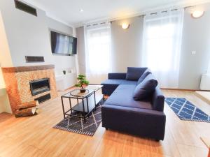 a living room with a couch and a fireplace at Apartament Kominek in Giżycko