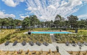 a swimming pool in a field with chairs at Moon in Binz