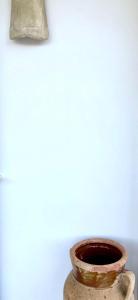 a vase sitting in front of a white wall at Dimora delle Tonnare in Favignana
