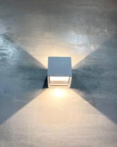 a table with a light in the middle of a room at Dimora delle Tonnare in Favignana