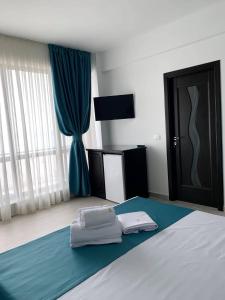 a bedroom with a bed with two pillows on it at Pensiunea DeeaMar in Năvodari +16 photos