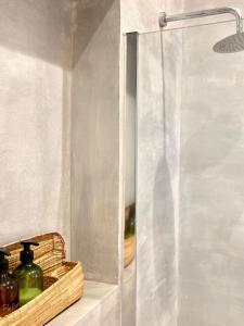 a glass shower stall with bottles on a shelf at Dimora delle Tonnare in Favignana