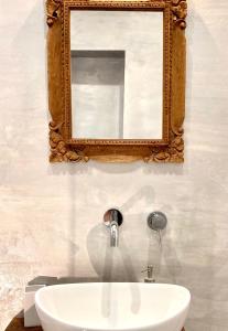 a bathroom with a sink and a mirror on the wall at Dimora delle Tonnare in Favignana