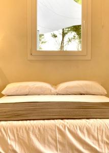 a bed in a room with a window at Dimora delle Tonnare in Favignana