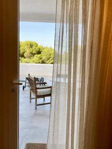 a door with a view of a patio with a bench at Dimora delle Tonnare in Favignana