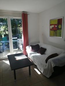 una camera da letto con un letto, un tavolo e una finestra di Agréable duplex équipé au Domaine d'Albret a Barbaste