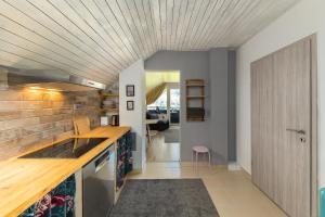 a kitchen with a wooden ceiling and a counter top at Rož'ca apartments with mountain view in Mojstrana