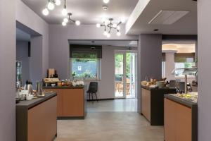a large kitchen with counters and a dining area at Boutique hotel Lili in Rovinj
