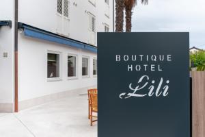 a sign that reads boutique hotel lulu in front of a building at Boutique hotel Lili in Rovinj